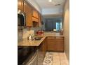 Galley kitchen featuring granite countertops, stainless steel appliances, and modern finishes at 303 Heritage Pkwy, Fort Mill, SC 29715