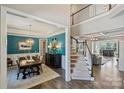 Dining room boasts stylish light fixture, wainscoting, and seamlessly connects to the living spaces at 305 Decanting Ln, Fort Mill, SC 29707