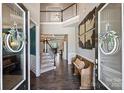 Elegant foyer featuring hardwood floors, staircase, and stylish decorations for a grand entrance at 305 Decanting Ln, Fort Mill, SC 29707