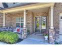 Inviting front porch with seating, double doors, and decorative wreaths welcomes visitors at 305 Decanting Ln, Fort Mill, SC 29707
