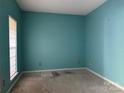 This empty bedroom features teal walls and a window with a window shade at 3898 Longwood Sw Dr, Concord, NC 28027