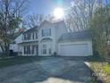 Bright two story home featuring an attached two car garage and well-manicured lawn at 3898 Longwood Sw Dr, Concord, NC 28027