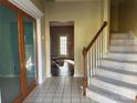 Inviting foyer with tile flooring, staircase, and glass paneled doors, creating a welcoming entrance at 3898 Longwood Sw Dr, Concord, NC 28027
