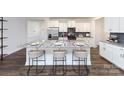 Modern kitchen with white cabinets, granite countertops, stainless steel appliances, and a large island at 4224 Steel Way, Sherrills Ford, NC 28673