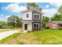Charming two-story home with a modern gray and white exterior, complemented by lush lawn at 424 Airline Ave, Shelby, NC 28150