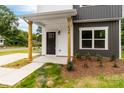 The front porch features wooden support columns and a black front door, enhancing the home's curb appeal at 424 Airline Ave, Shelby, NC 28150