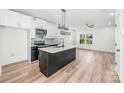 Spacious, open kitchen with modern finishes, a kitchen island, stainless appliances, and hardwood flooring at 424 Airline Ave, Shelby, NC 28150