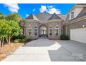 Stunning brick home with arched windows, lush landscaping, and a spacious driveway at 458 Inverness Pl, Rock Hill, SC 29730