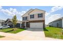 Charming two-story home with stone accents, gray siding, a well-manicured lawn, and attached two car garage at 4623 Harris Elliot Rd, Lincolnton, NC 28092