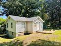 Side view of a two-story home with vinyl siding and a gabled roof at 506 Sycamore Ave, Gastonia, NC 28052