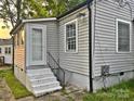 Exterior side door access with white steps, gray vinyl siding, and black accents at 520 Margaret Dr, Statesville, NC 28677