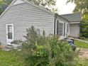 Side view of the home showcasing the light gray vinyl siding, windows, and door at 520 Margaret Dr, Statesville, NC 28677