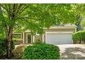 Inviting home featuring lush landscaping, stone-lined steps, and a two-car garage at 6434 Skyline Dr, Charlotte, NC 28269