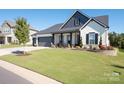 Charming single-Gathering home featuring manicured lawn and classic architectural details at 7112 Irongate Dr, Indian Land, SC 29707