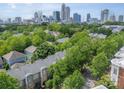 Gorgeous aerial view of the city skyline overlooking lush green treetops and neighborhood townhomes at 738 Garden District Dr, Charlotte, NC 28202