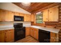 Efficient kitchen featuring wood cabinets, modern appliances and lots of natural light at 8464 Robinson Church Rd, Charlotte, NC 28215