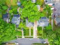 Aerial view of home nestled among trees, showcasing neighborhood layout and verdant surroundings at 907 Edgewood Cir, Gastonia, NC 28052