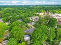 Expansive aerial view of a neighborhood showcasing tree cover, architecture, and community layout at 907 Edgewood Cir, Gastonia, NC 28052