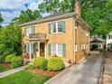 Classic two-story brick home with green shutters and a private balcony, set on a lush lot at 907 Edgewood Cir, Gastonia, NC 28052