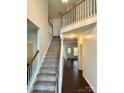 Grand entryway showcases hardwood floors, a staircase, and natural light at 9907 Furlong Trl, Charlotte, NC 28269