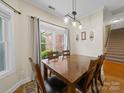 Inviting dining room features natural light and a classic chandelier over a wood table at 1021 Mallard Landing Dr, Monroe, NC 28110