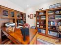 Well-appointed office with custom wood built-ins offers a refined workspace at 1021 Mallard Landing Dr, Monroe, NC 28110