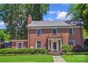 Inviting two-story brick home with a manicured lawn and a classic front porch at 1101 Pee Dee Ave, Albemarle, NC 28001