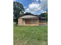 Brick home featuring a charming covered porch and well-maintained lawn at 1120 Mcintyre Rd, Wingate, NC 28174