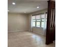 Bright living room featuring neutral walls, tile flooring and a large window at 1120 Mcintyre Rd, Wingate, NC 28174
