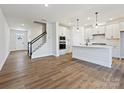 Open floor plan with new kitchen featuring quartz countertops, island, and modern appliances at 11455 Prosperity Church Rd, Huntersville, NC 28078