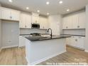 Bright new kitchen featuring white cabinets, dark counter tops, and stainless steel appliances at 11455 Prosperity Church Rd, Huntersville, NC 28078