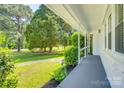 View from the covered porch of the well manicured front yard and mature shade trees at 1423 Ebinport Rd, Rock Hill, SC 29732