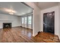 Spacious living room featuring hardwood floors, fireplace and natural light from large windows at 1423 Ebinport Rd, Rock Hill, SC 29732