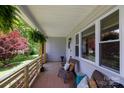 Relaxing covered porch featuring comfortable wicker furniture and serene outdoor views at 1423 N New Hope Rd, Gastonia, NC 28054