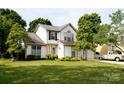 Beautiful two-story home boasting a well-kept lawn, mature trees, and a two-car garage, radiating suburban charm at 14406 Gadwall Ct, Charlotte, NC 28273