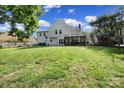 Expansive backyard featuring lush green grass, a screened-in porch, and mature trees offers generous outdoor space at 1506 Ivy Bluff Way, Matthews, NC 28105