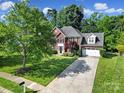 Beautiful two-story home featuring an attached two-car garage and a long driveway, all enhanced by mature trees at 1506 Ivy Bluff Way, Matthews, NC 28105