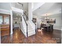 Inviting foyer with hardwood floors, staircase, and adjacent dining room creates an elegant and welcoming entry space at 1506 Ivy Bluff Way, Matthews, NC 28105