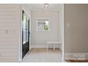 Bright entryway with wood floors, bench seating, and shiplap accent wall at 1513 Landis Ave, Charlotte, NC 28205