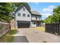 Charming two-story home featuring a modern gray exterior, a two-car garage, and a well-manicured front lawn at 1513 Landis Ave, Charlotte, NC 28205