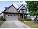 Charming two-story home with a two car garage, manicured lawn, and beautiful architectural details at 159 Saye Pl, Mooresville, NC 28115