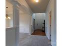 Welcoming foyer featuring detailed trim work, archways, carpet, and hardwood floors that offer a sense of arrival at 159 Saye Pl, Mooresville, NC 28115