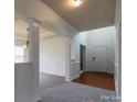 Elegant foyer with hardwood floors, wainscoting, and a grand archway, creating a welcoming entrance at 159 Saye Pl, Mooresville, NC 28115