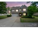Charming two-story home featuring a brick and siding exterior, well-maintained landscaping, and a two-car garage at 16114 Foreleigh Rd, Huntersville, NC 28078