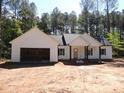 New construction home featuring a welcoming front porch, attached garage, and stylish exterior with trees in the background at 1761 Every Dr, Iron Station, NC 28080