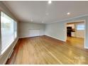 Bright living room featuring gleaming hardwood floors and fresh paint at 2001 Tyvola Rd, Charlotte, NC 28210