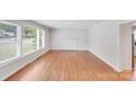 Bright living room featuring large windows, hardwood floors, and a fireplace mantle at 2001 Tyvola Rd, Charlotte, NC 28210