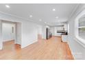 Spacious living area with hardwood floors seamlessly connecting to the kitchen and laundry area at 2001 Tyvola Rd, Charlotte, NC 28210