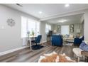 Open-concept living room featuring wood flooring, a comfortable sitting area, and a functional desk space at 2012 Double Oaks Rd, Charlotte, NC 28206