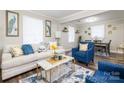 Bright living room with elegant furnishings, a marble coffee table, and a seamless flow into the dining area at 2012 Double Oaks Rd, Charlotte, NC 28206